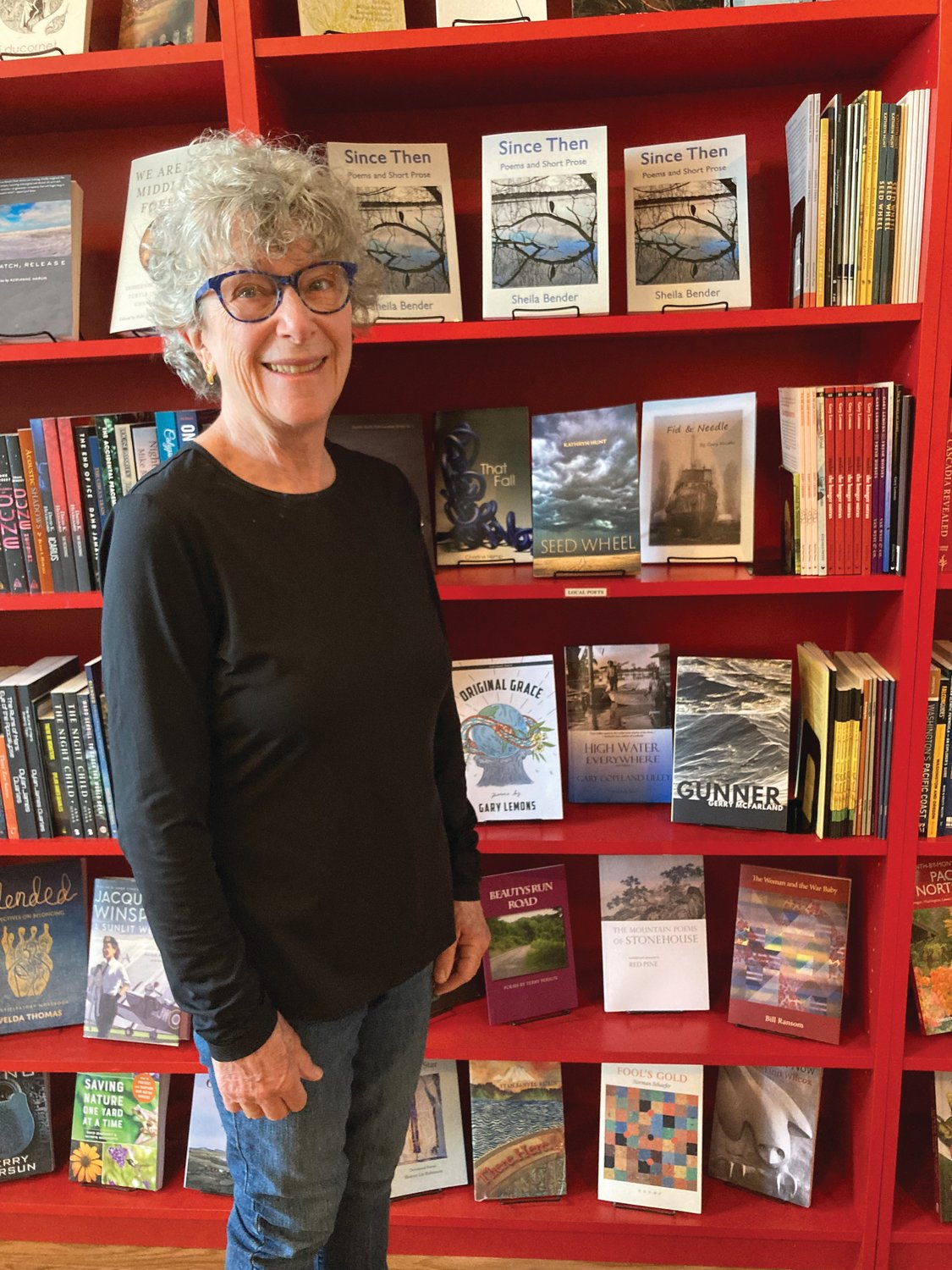 Sheila Bender stands alongside the shelf holding her book new book, “Since Then,” at Imprint Bookstore in downtown Port Townsend.